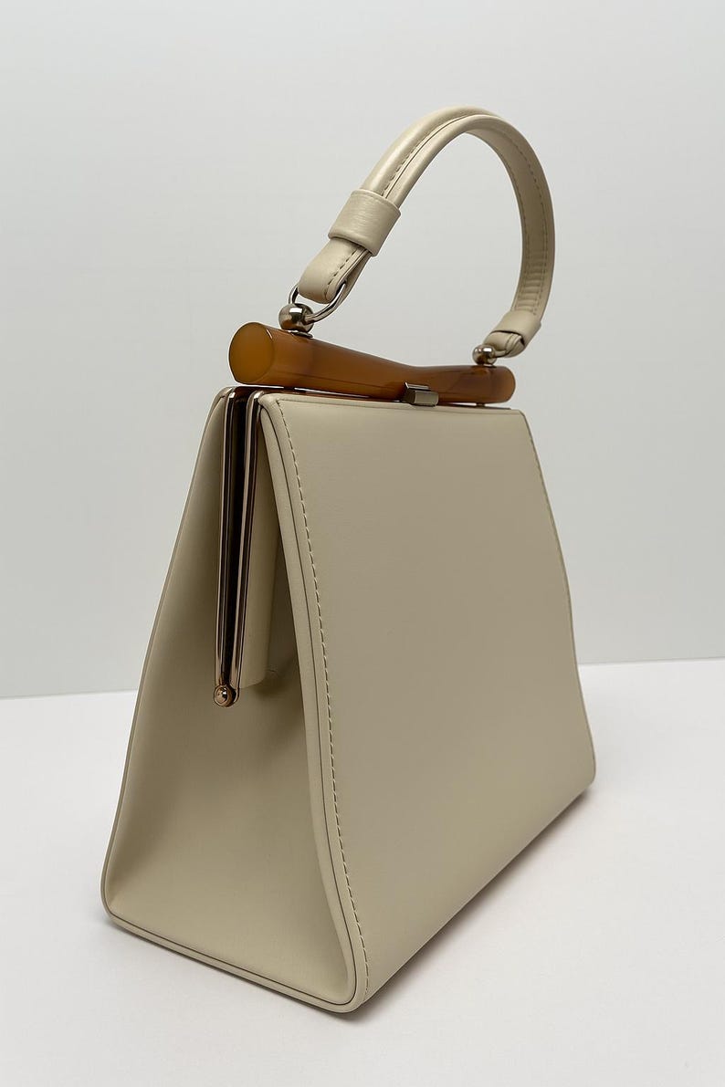 1960s Theodore of California Cream Faux Patent Leather Handbag Amber Frame Vintage Purse